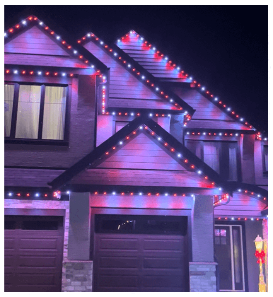Purple roofline lights outlining a house and garage at night